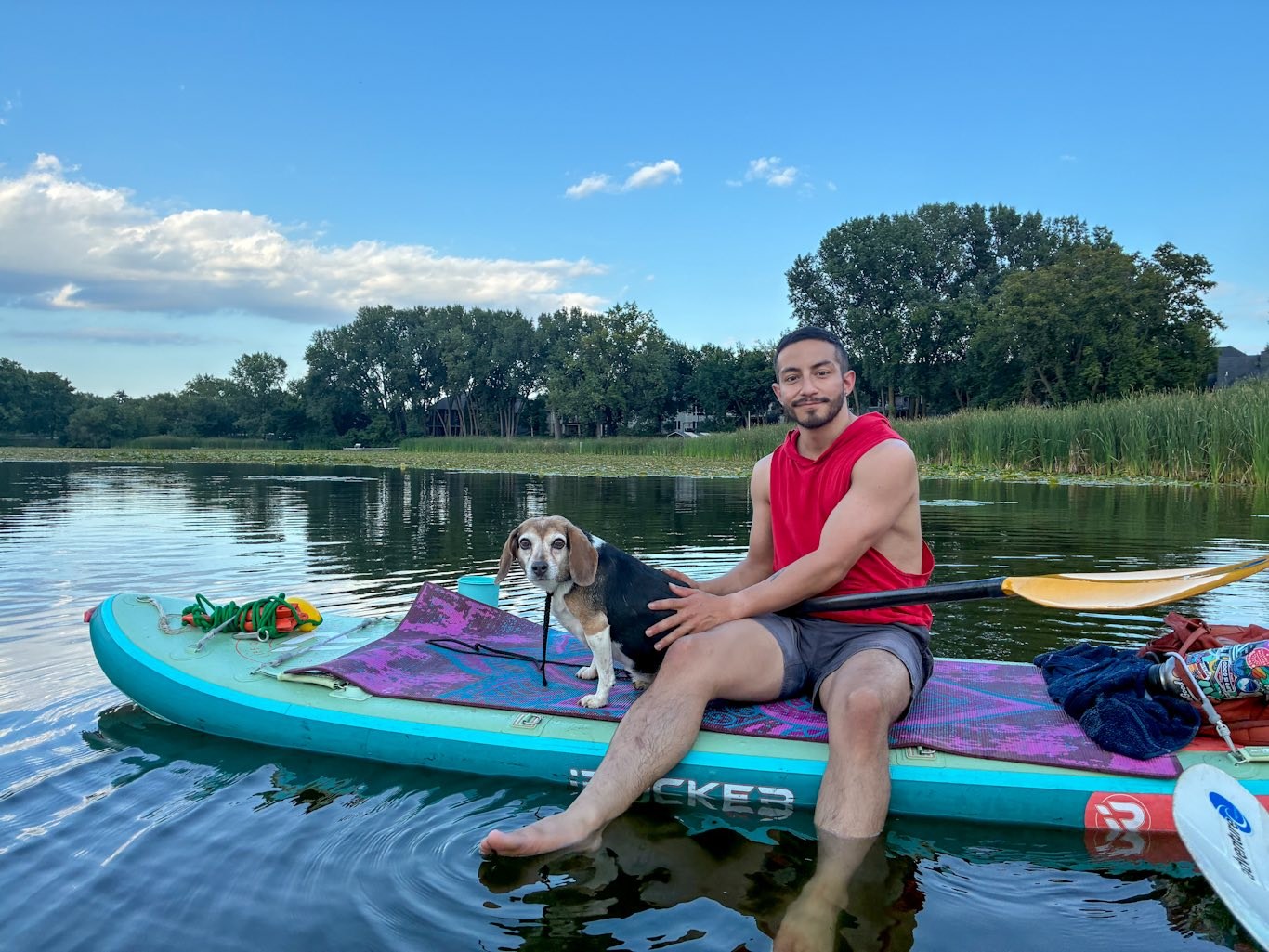 Ramiro and Andy on a paddleboard at the lake